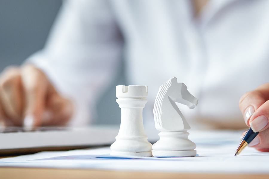 Chess pieces symbolize strategizing to achieve killer client relations.